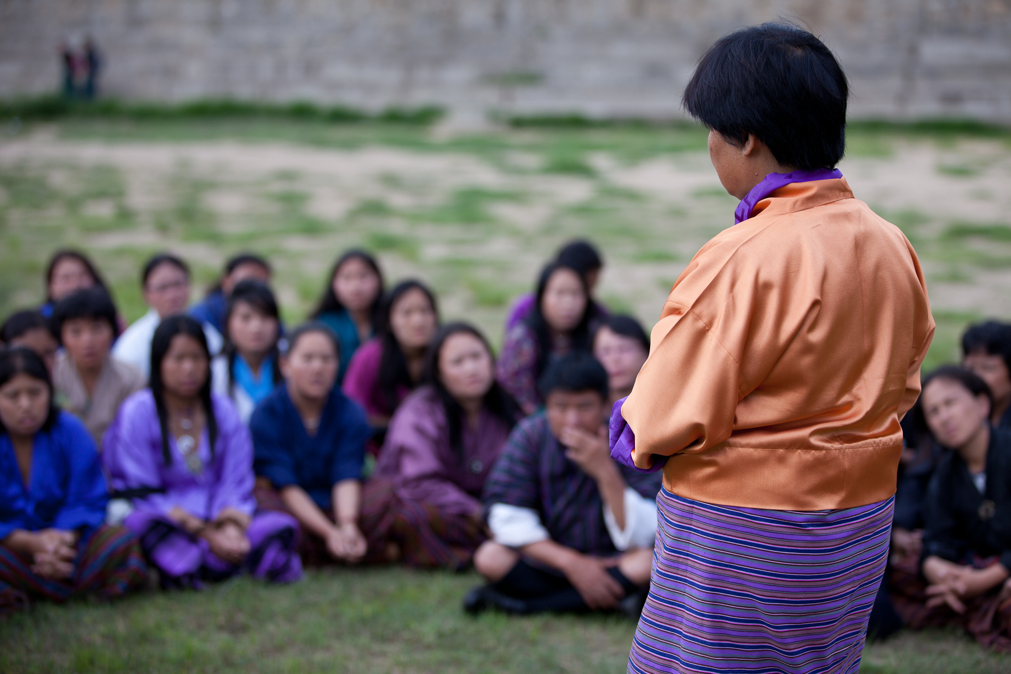 A counselor speaking as participants look on. 