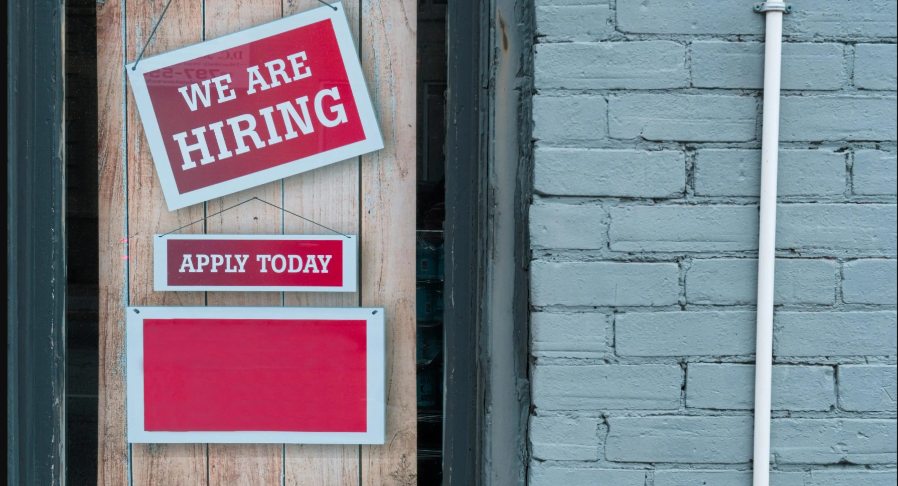 A banner with a we are hiring sign. 