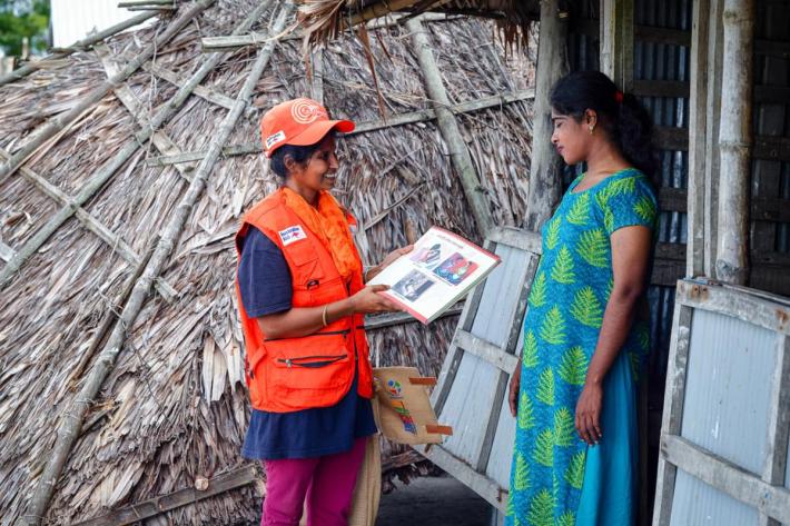 A community volunteer counsels her client during a humanitarian response. 