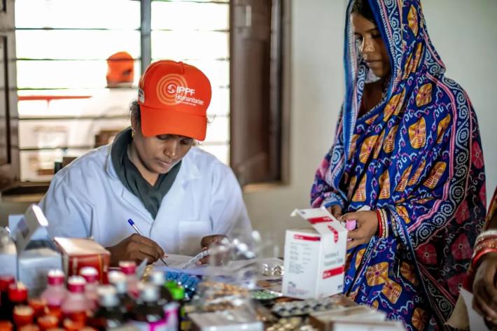 A client receives the contraceptive pill for the first time from the clinic staff of Family Planning Association of India