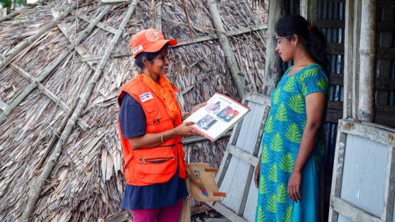 A community volunteer counsels her client during a humanitarian response. 