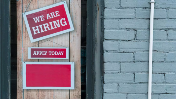 A banner with a we are hiring sign. 