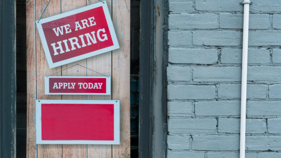 A banner with a we are hiring sign. 